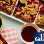 Brown butter apple and blackberry bars on a trap, with some in a lunchbox and some on a napkin, and drinks alongside