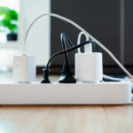 Multiple devices plugged into a single surge protector power strip.